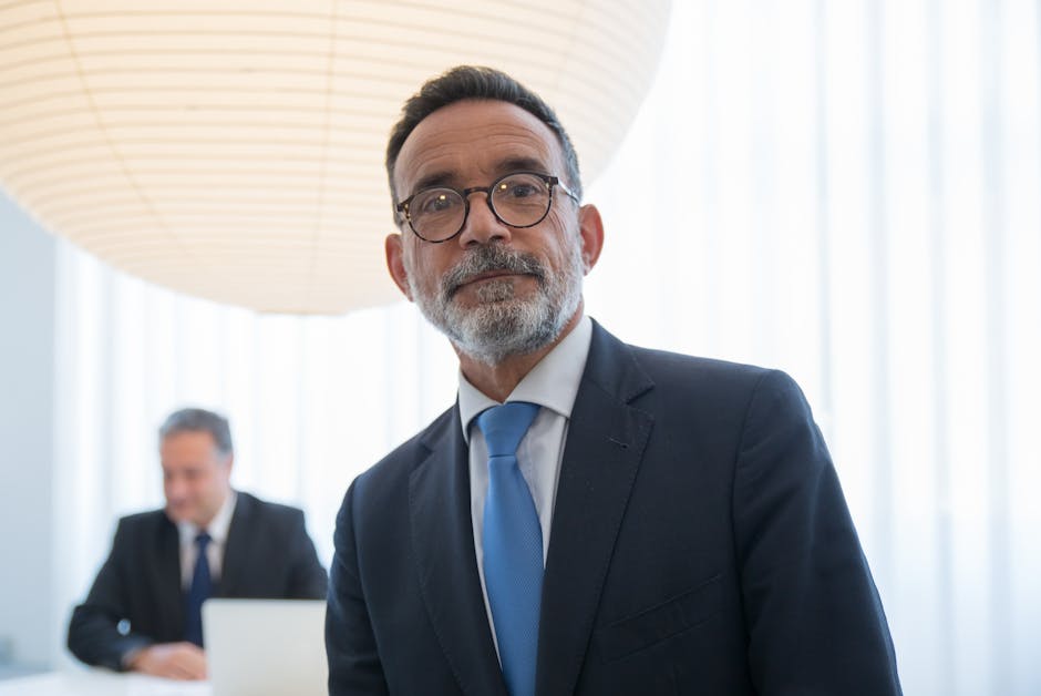 Confident senior executive in formal attire with modern office background